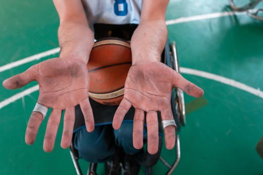 the hands of disabled basketball players after an exhausting game in the arena. Selective focus. High quality photo
