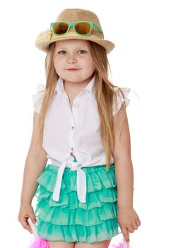 Close-up.Cute little girl with long blonde hair below shoulders , wearing a hat and sunglasses . Girl holding in hands a pink tinsel- Isolated on white background