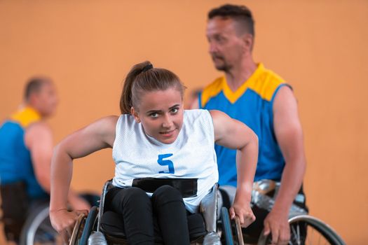 a young woman playing wheelchair basketball in a professional team. Gender equality, the concept of sports with disabilities. . High quality photo.Selective focus 