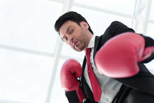 close up.a serious businessman in red Boxing gloves .photo with copy space