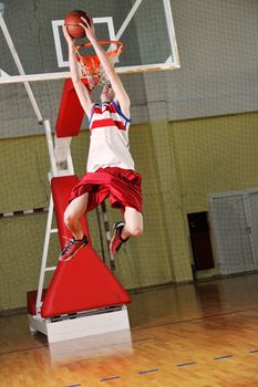 young healthy man play basketball game indoor in gym