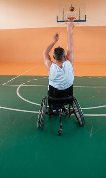 a cameraman with professional equipment records a match of the national team in a wheelchair playing a match in the arena. High quality photo. Selective focus 