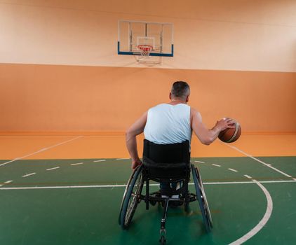 a cameraman with professional equipment records a match of the national team in a wheelchair playing a match in the arena. High quality photo. Selective focus 