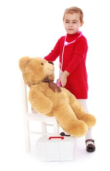 Gentle little girl playing doctor with Teddy bear - Isolated on white background