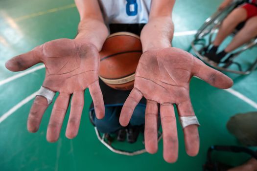 the hands of disabled basketball players after an exhausting game in the arena. Selective focus. High quality photo