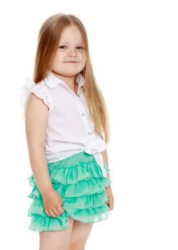 Caucasian little girl with long blond hair below the shoulders ,in a short green skirt . The little girl turned sideways to the camera . close-up - Isolated on white background