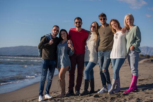 portrait of group Friends Spending The Day On A Beach during autumn day