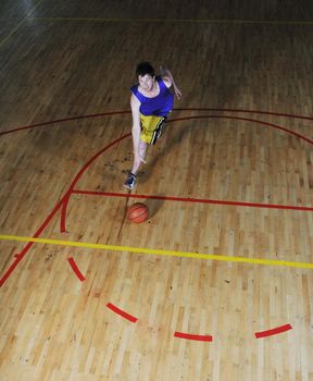 one healthy young  man play basketball game in school gym indoor