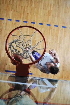 one healthy young  man play basketball game in school gym indoor