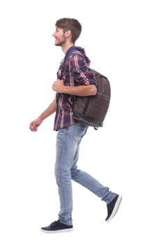 in full growth. a handsome male student steps forward.isolated on white background.