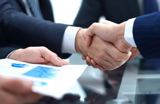 handshake business colleagues in office