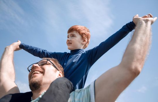 happy father has a little son on his shoulders.the concept of fatherhood