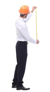 in full growth. young architect with yellow tape measure. isolated on white background