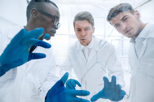 close up.a group of microbiologists discussing new ideas. education and science
