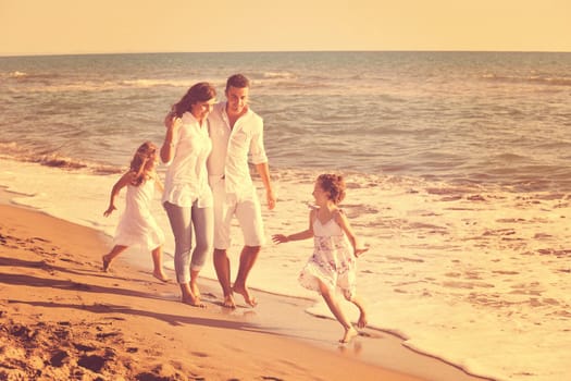 happy young family in white clothing have fun at vacations on beautiful beach 