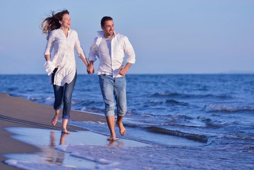 happy young romantic couple in love have fun on beautiful beach at beautiful summer day