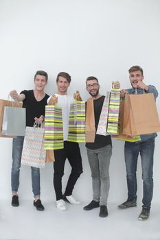 group of young men shows shopping bags. photo with copy space