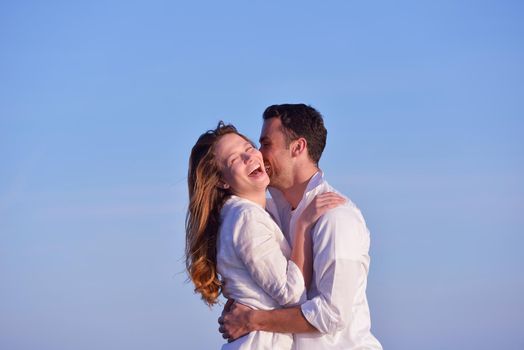 happy young romantic couple in love have fun on beautiful beach at beautiful summer day