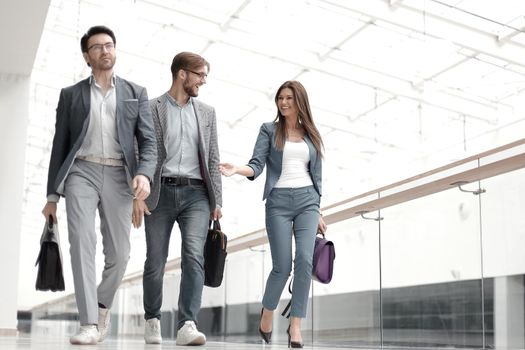 employees of the company are on the office corridor . business concept