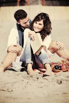 happy young couple enjoying  picnic on the beach and have good time on summer vacations