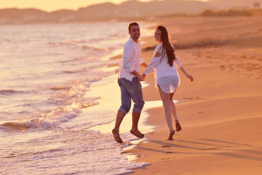 happy young romantic couple in love have fun on beautiful beach at beautiful summer day