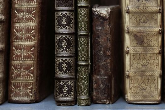 Old worn books on a shelf in the library's archives