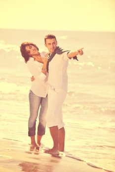 happy young couple in white clothing  have romantic recreation and   fun at beautiful beach on  vacations