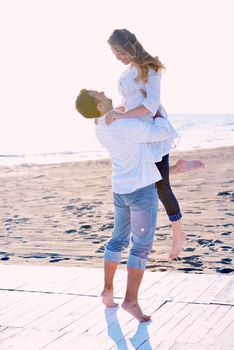 happy young romantic couple in love have fun on beautiful beach at beautiful summer day