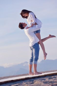 happy young romantic couple in love have fun on beautiful beach at beautiful summer day