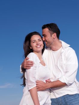 happy young romantic couple in love have fun on beautiful beach at beautiful summer day