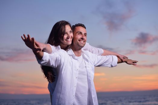 happy young romantic couple in love have fun on beautiful beach at beautiful summer day