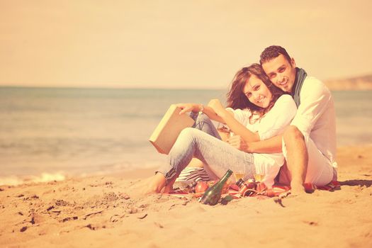 happy young couple enjoying  picnic on the beach and have good time on summer vacations