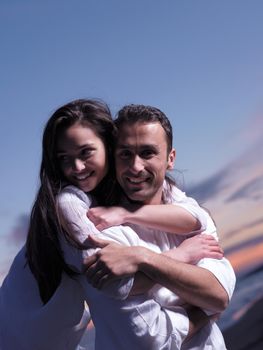 happy young romantic couple in love have fun on beautiful beach at beautiful summer day