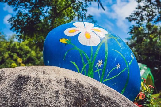 Multicolored eggs in the grass. Easter eggs hunt, outdoors. Celebrating Easter holiday.