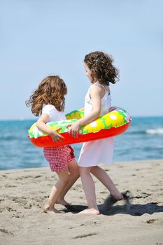 group of happy child on beach who have fun and play games