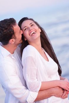 happy young romantic couple in love have fun on beautiful beach at beautiful summer day