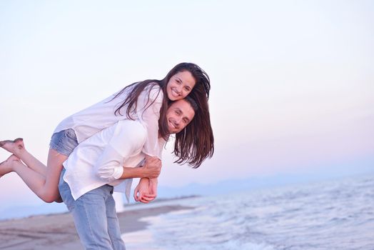 happy young romantic couple in love have fun on beautiful beach at beautiful summer day