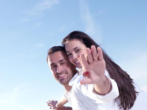 happy young romantic couple in love have fun on beautiful beach at beautiful summer day