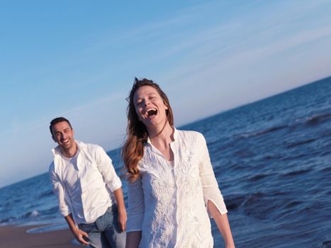 happy young romantic couple in love have fun on beautiful beach at beautiful summer day