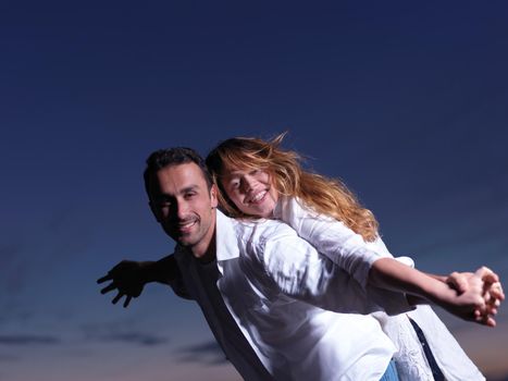 happy young romantic couple in love have fun on beautiful beach at beautiful summer day