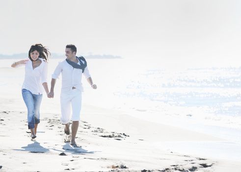 happy young couple in white clothing  have romantic recreation and   fun at beautiful beach on  vacations