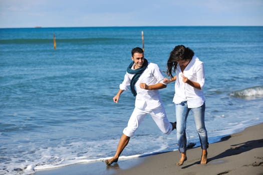 happy young couple in white clothing  have romantic recreation and   fun at beautiful beach on  vacations