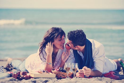 happy young couple enjoying  picnic on the beach and have good time on summer vacations