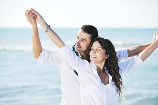 happy young couple in white clothing  have romantic recreation and   fun at beautiful beach on  vacations