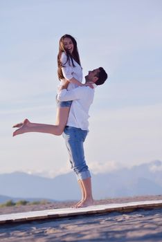 happy young romantic couple in love have fun on beautiful beach at beautiful summer day