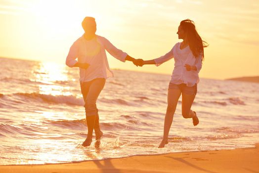 happy young romantic couple in love have fun on beautiful beach at beautiful summer day