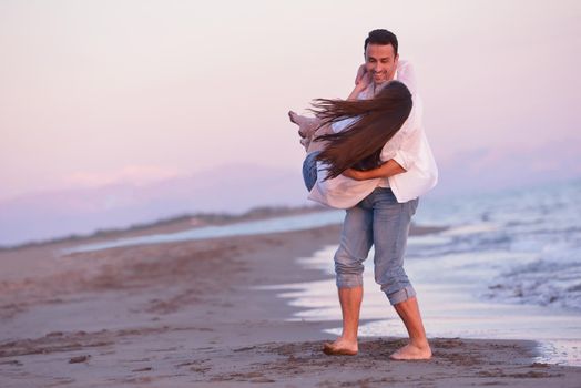 happy young romantic couple in love have fun on beautiful beach at beautiful summer day