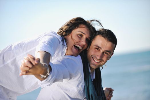 happy young couple in white clothing  have romantic recreation and   fun at beautiful beach on  vacations