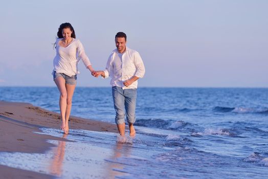 happy young romantic couple in love have fun on beautiful beach at beautiful summer day