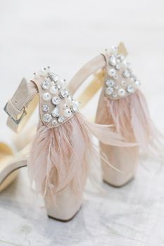 Closeup bridal shoes on white background. Concept of wedding elements.